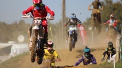 Action shot of a motocross athlete soaring through the air, highlighting the adrenaline and precision of the sport