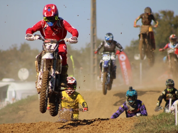 Action shot of a motocross athlete soaring through the air, highlighting the adrenaline and precision of the sport