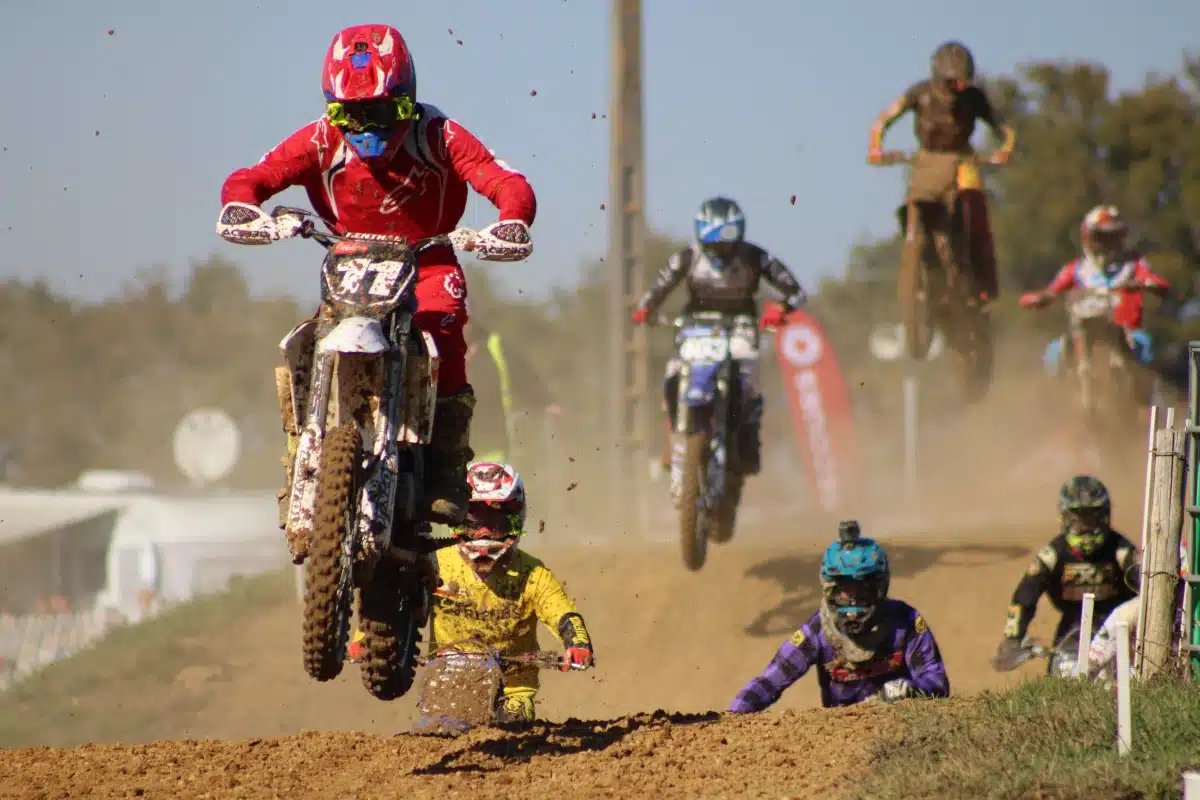 Action shot of a motocross athlete soaring through the air, highlighting the adrenaline and precision of the sport