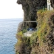 Private blue terrace seating on a steep cliffside balcony overlooking the Ligurian Sea in Cinque Terre, Italy.
