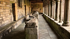 The Gothic cloister of Tréguier Cathedral in Brittany, showing the perspective of the stone gallery and medieval recumbent effigies