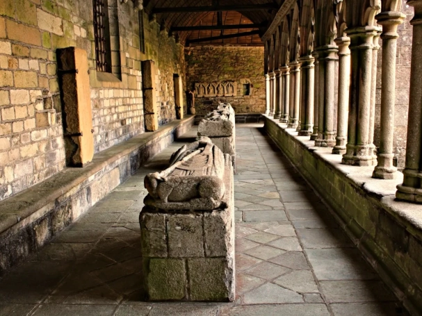 The Gothic cloister of Tréguier Cathedral in Brittany, showing the perspective of the stone gallery and medieval recumbent effigies