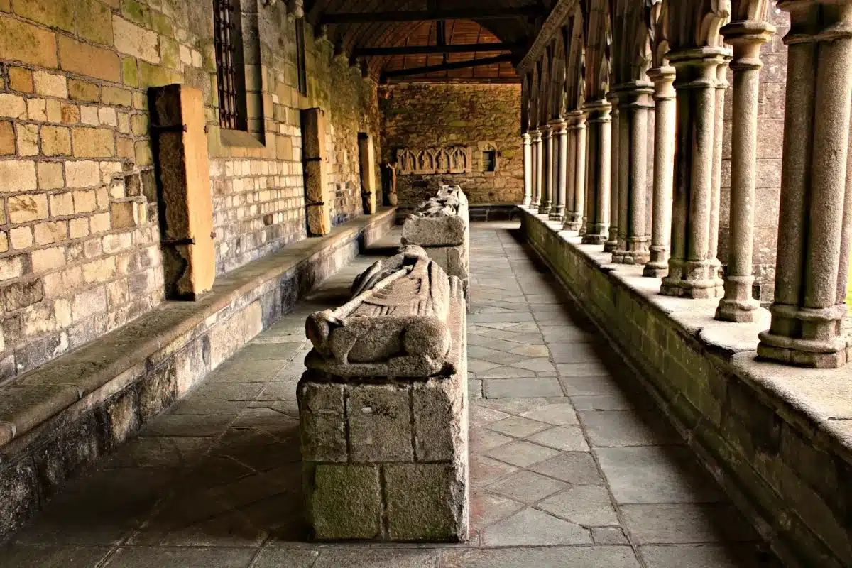 The Gothic cloister of Tréguier Cathedral in Brittany, showing the perspective of the stone gallery and medieval recumbent effigies